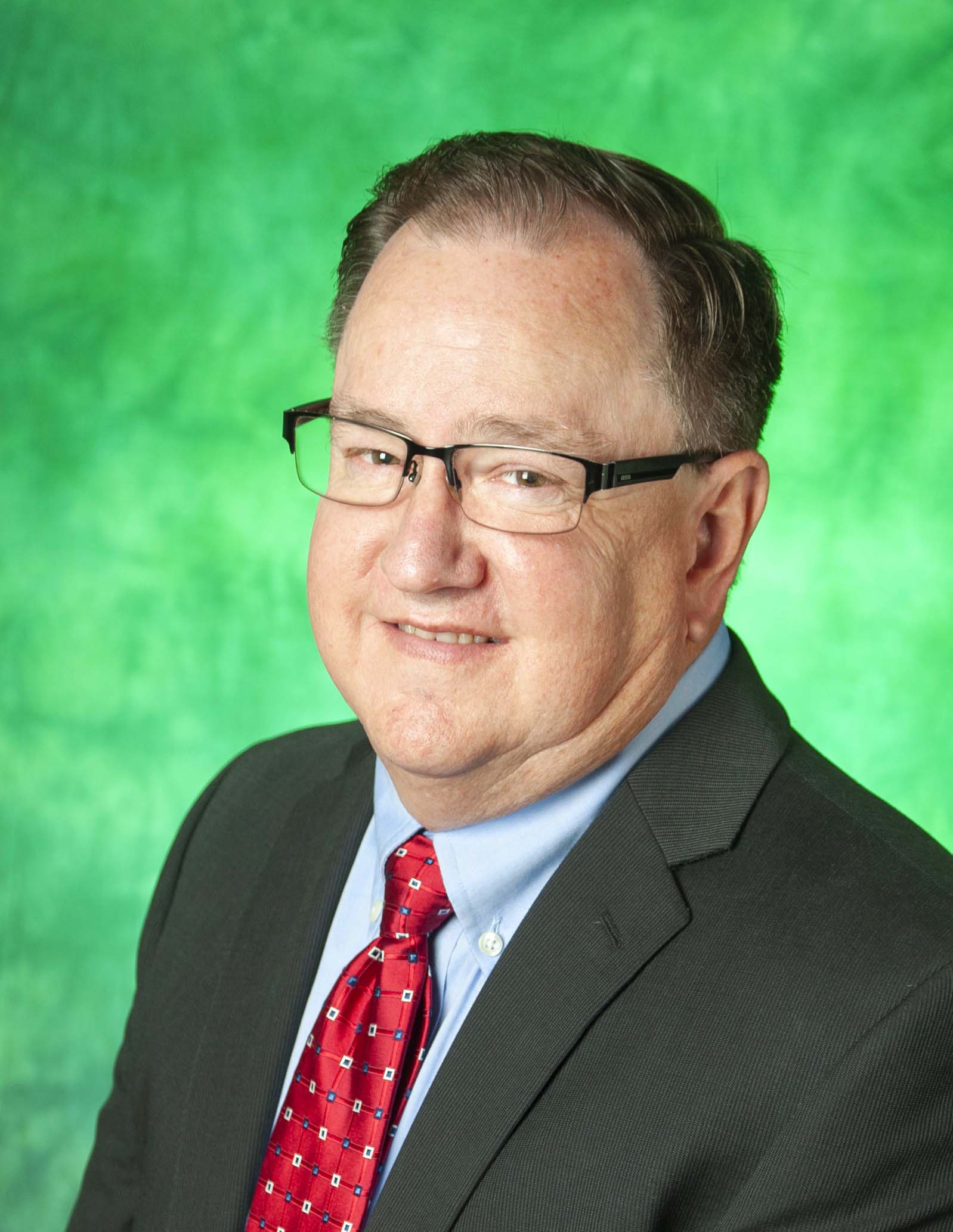 Man wearing glasses and a red tie. 